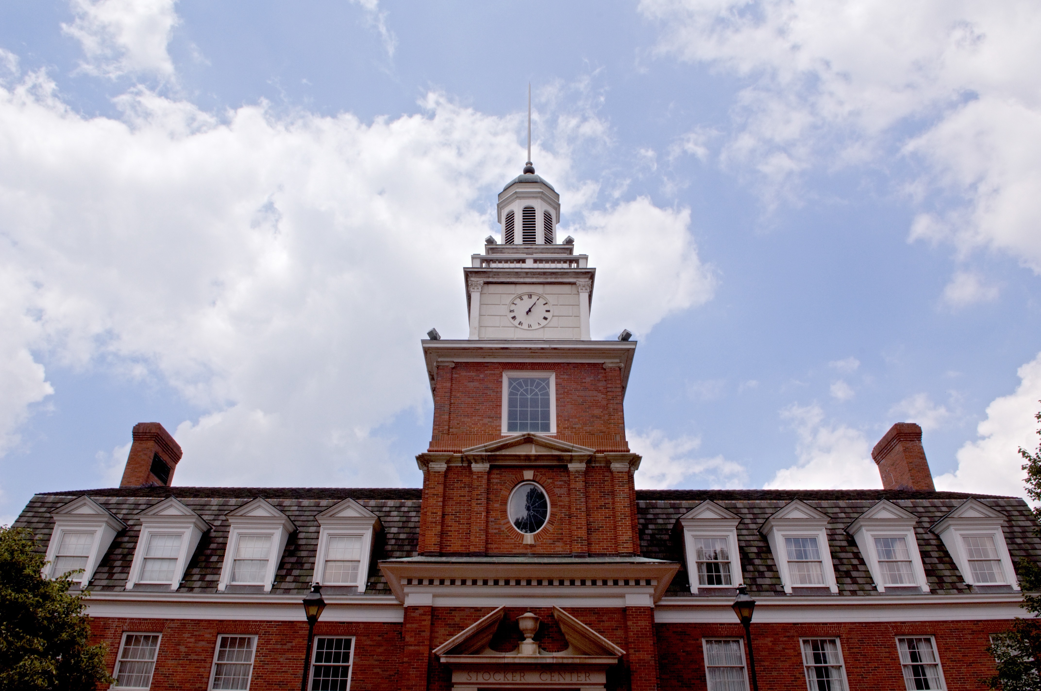 Ohio University's Stocker Center is bordered by a blue sky with clouds.