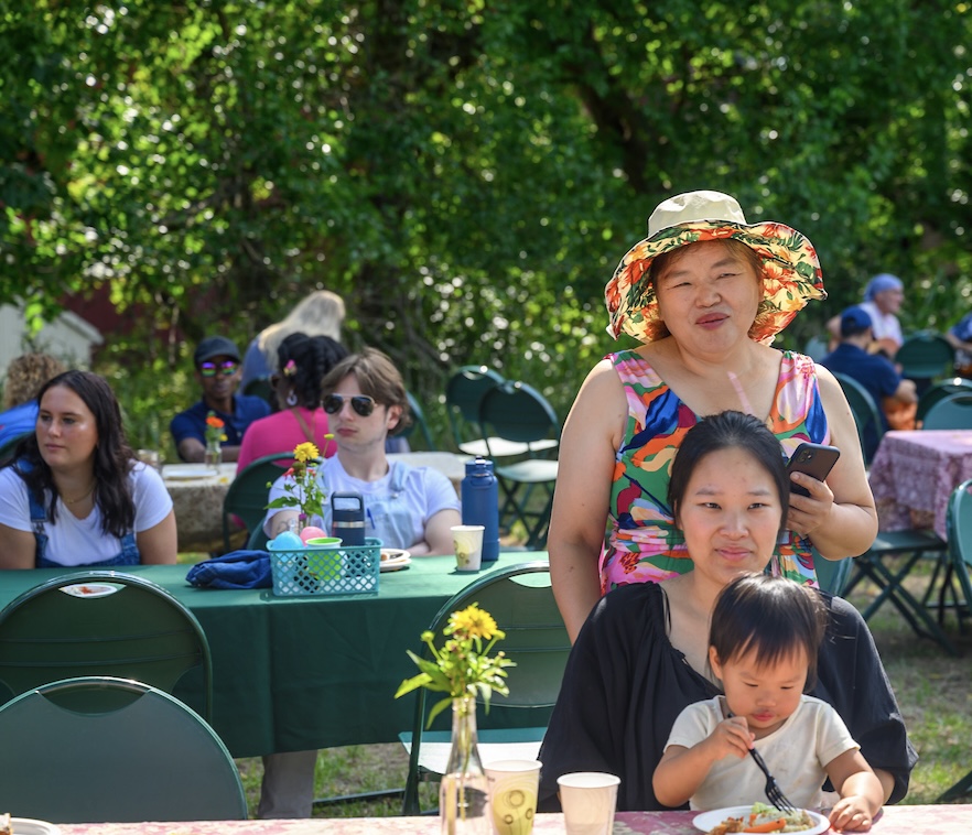 Families sit and eat at a decorated table