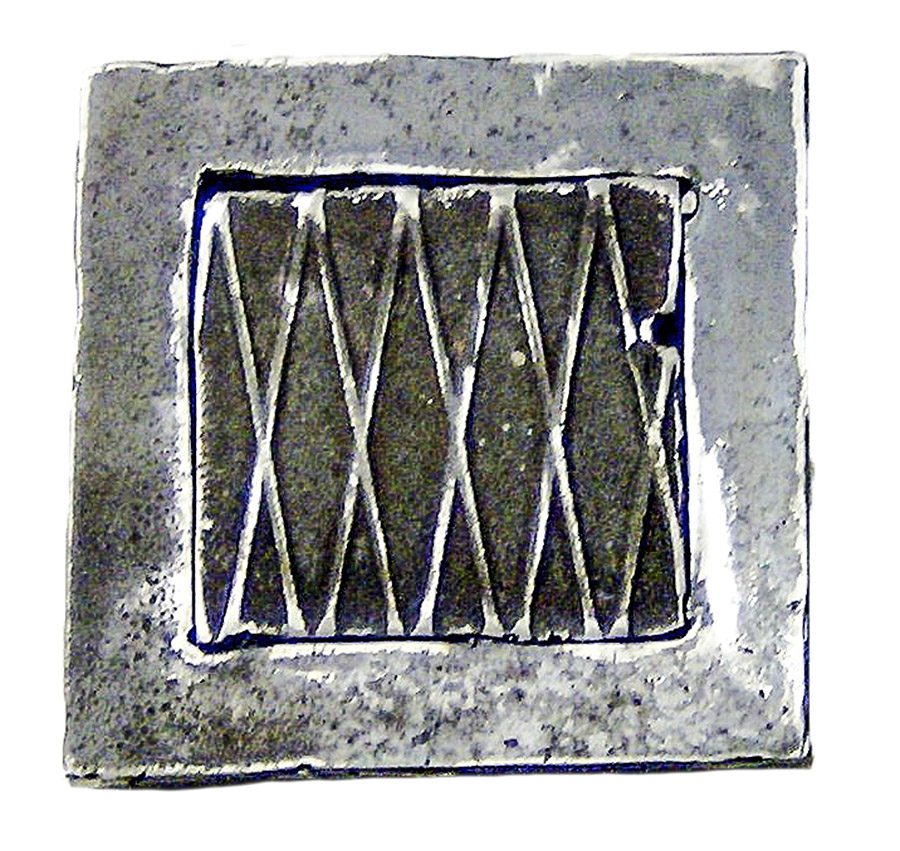 an irregular square of metal with five X shapes inside a frame