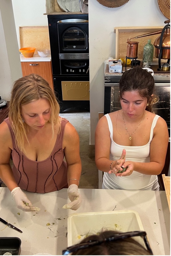 two women cook at a counter