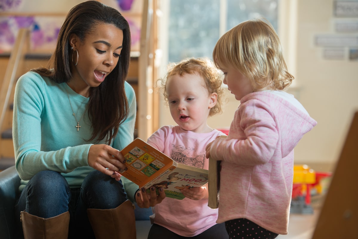 An OHIO student reads to two young children as part of the Early Childhood Education program at Ohio University