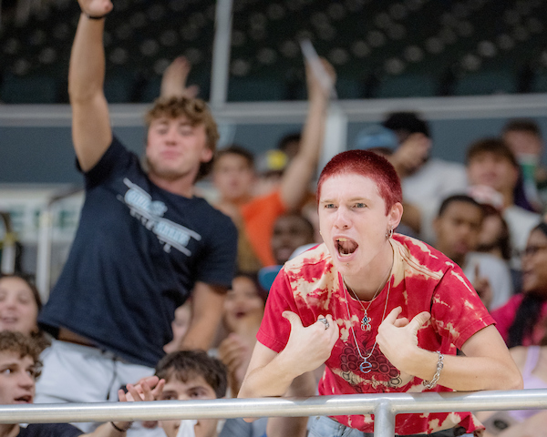 A student enthusiastically gestures from the crowd at the new student convocation