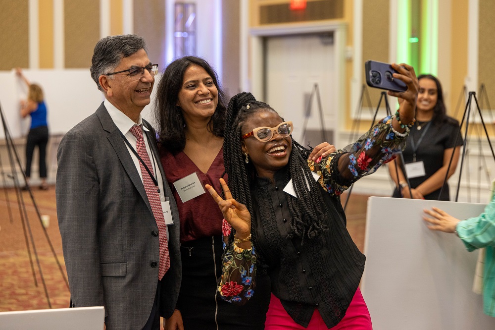 Conference attendees pose for a photo together in the Baker Ballroom