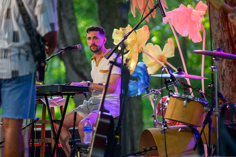 An artist performs on the Creekside Stage.