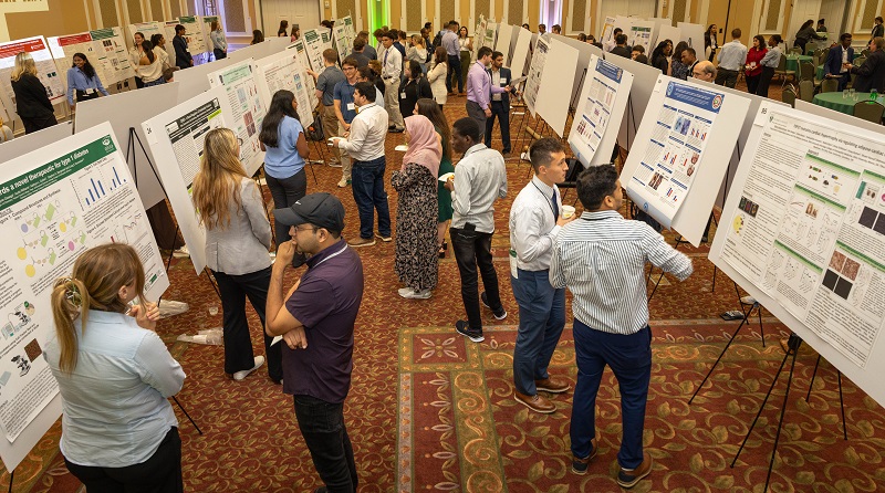 Students show their research posters in the Baker Ballroom at the annual conference