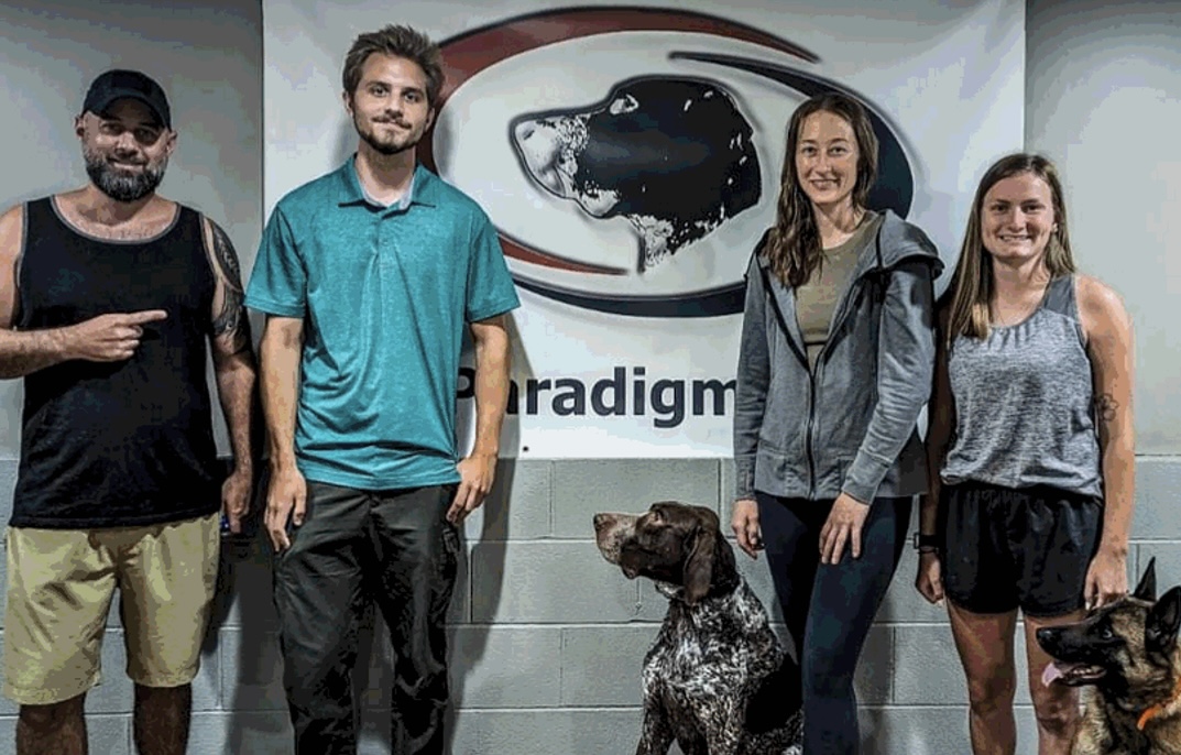 People pose for picture with dog