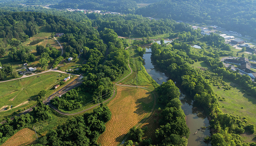 an aerial photo of the Hocking River and surrounding area, including a lush landscape of tree cover