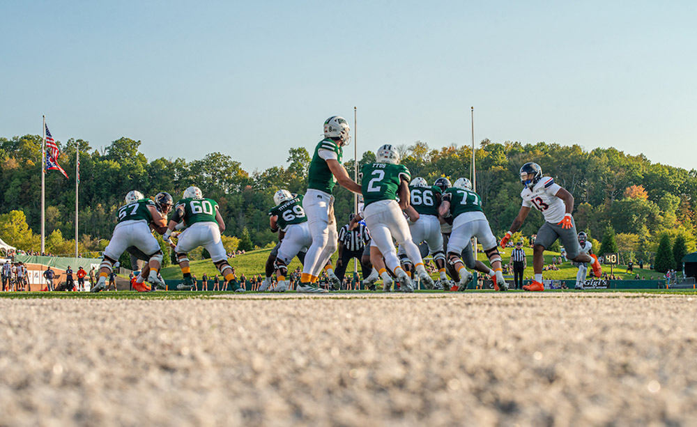 OHIO Football players huddle on the field during a game