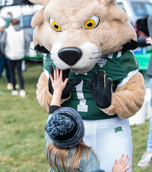 A young fan gives Rufus a high five outside of Peden Stadium.