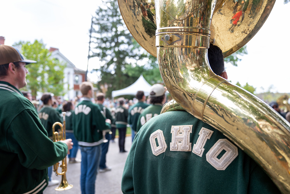 An OHIO graduate plays tuba in the alumni band during the Ohio University Homecoming parade