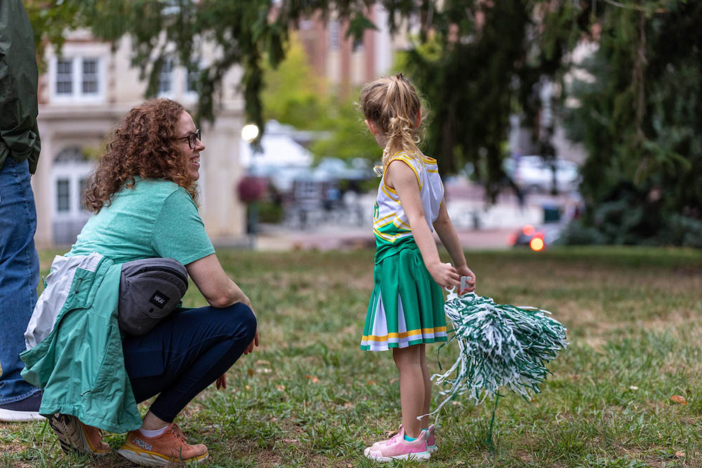 A woman addresses a young cheerleader at the Yell Like Hell pep rally, Homecoming 2024