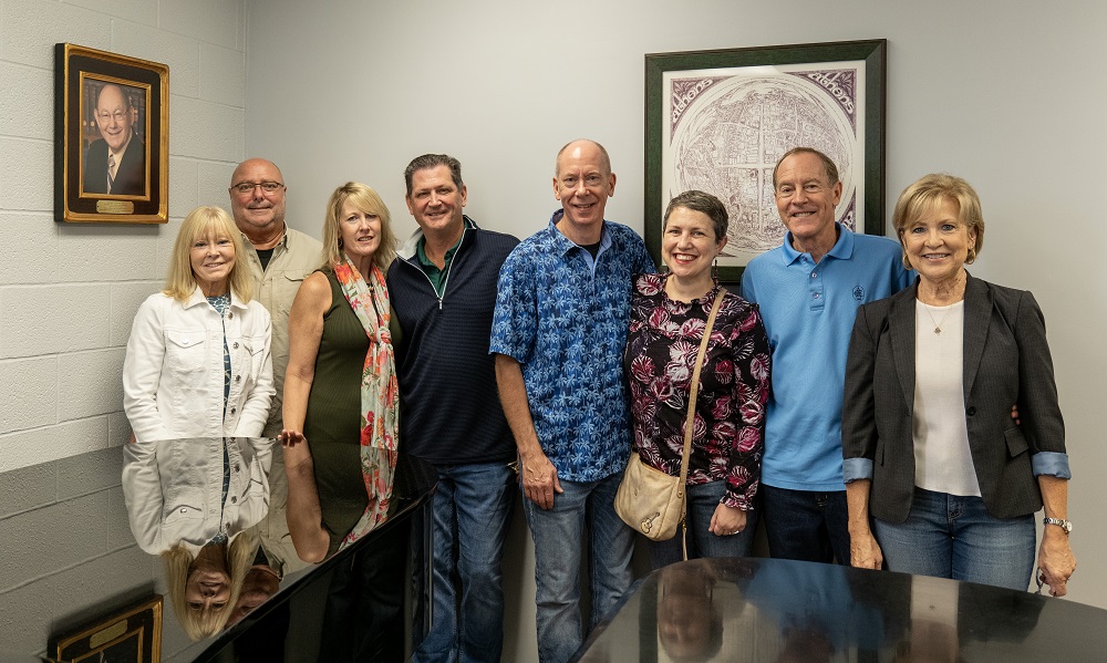 Family members and friends of Dr. Richard Wetzel pose for a photo near the piano