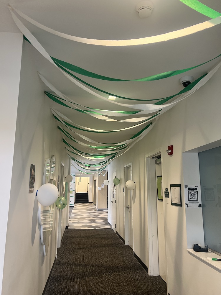 Green and white streamers and balloons decorate the hallway