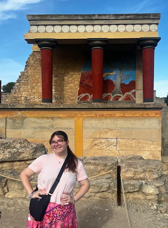 Student poses for photo in front of ancient ruins in Greece