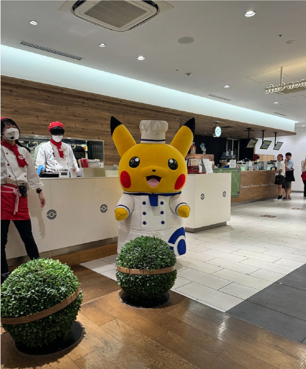 Someone wearing a Pikachu costume in an indoor setting.