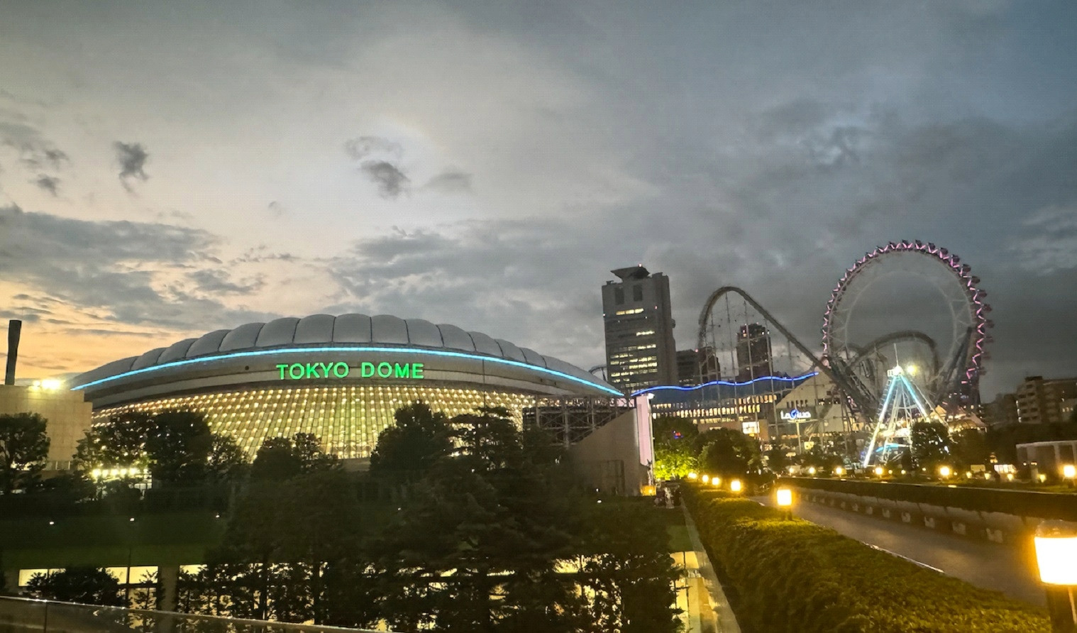 A city skyline with a ferris wheel and a large dome that reads "Tokyo Dome."