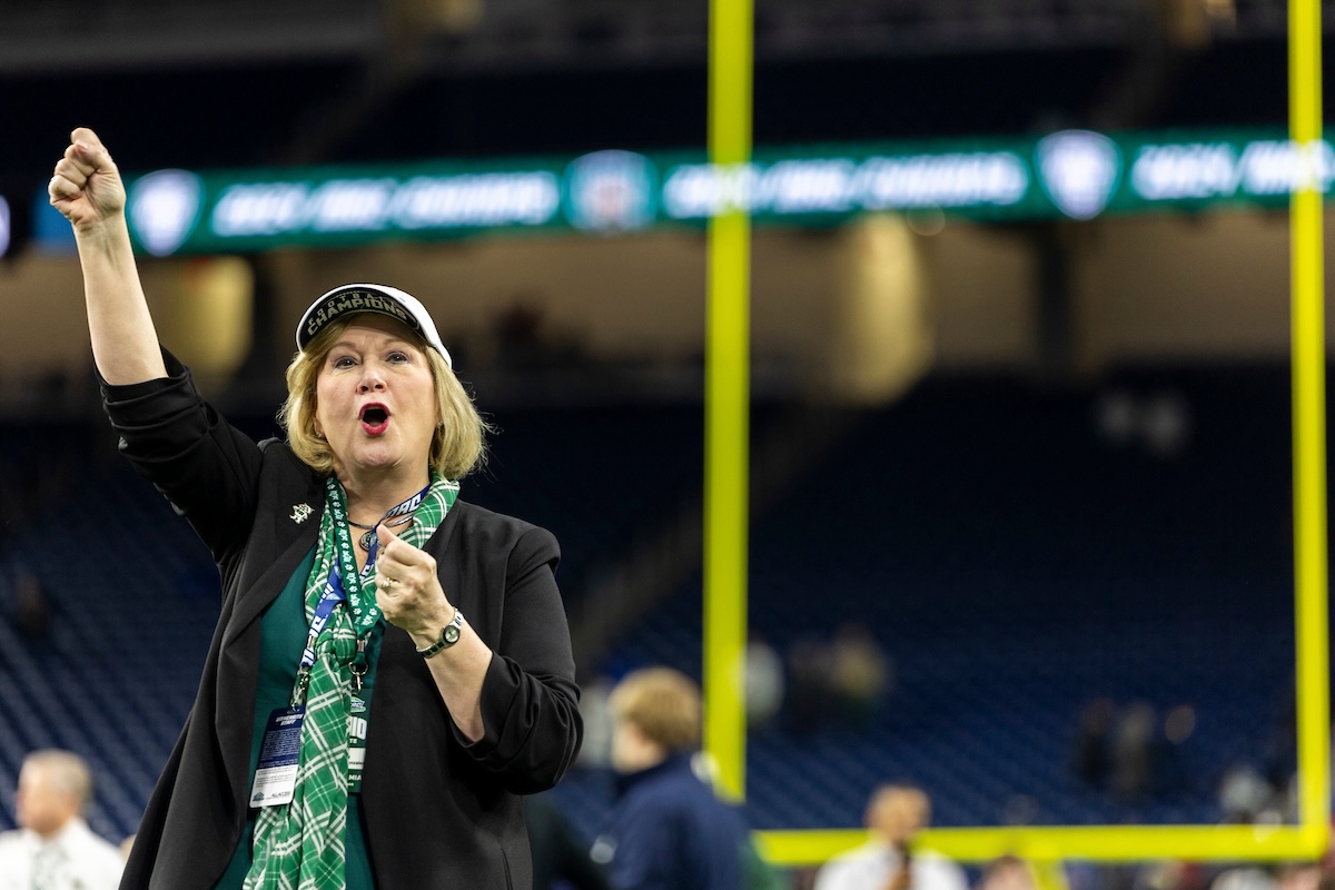 President Lori Stewart Gonzalez cheers on the Bobcats in the MAC Championship game