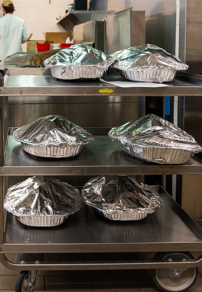 A cart holding foil-covered dishes