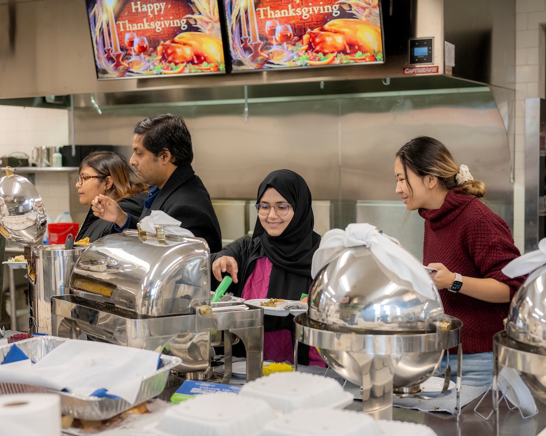 People make their way through the line at a buffet