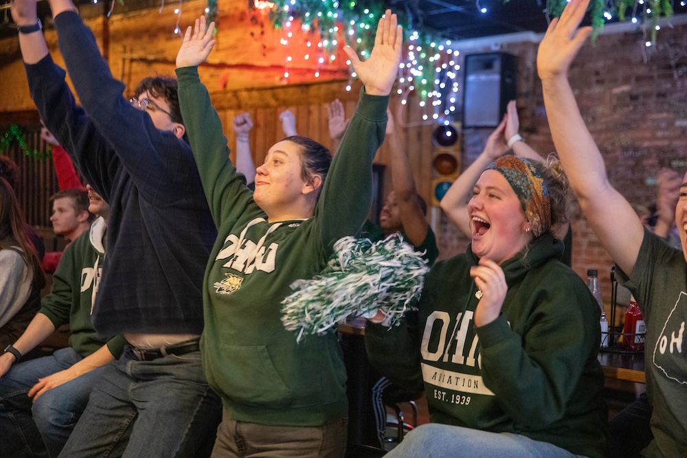 OHIO fans raise their hands in celebration 