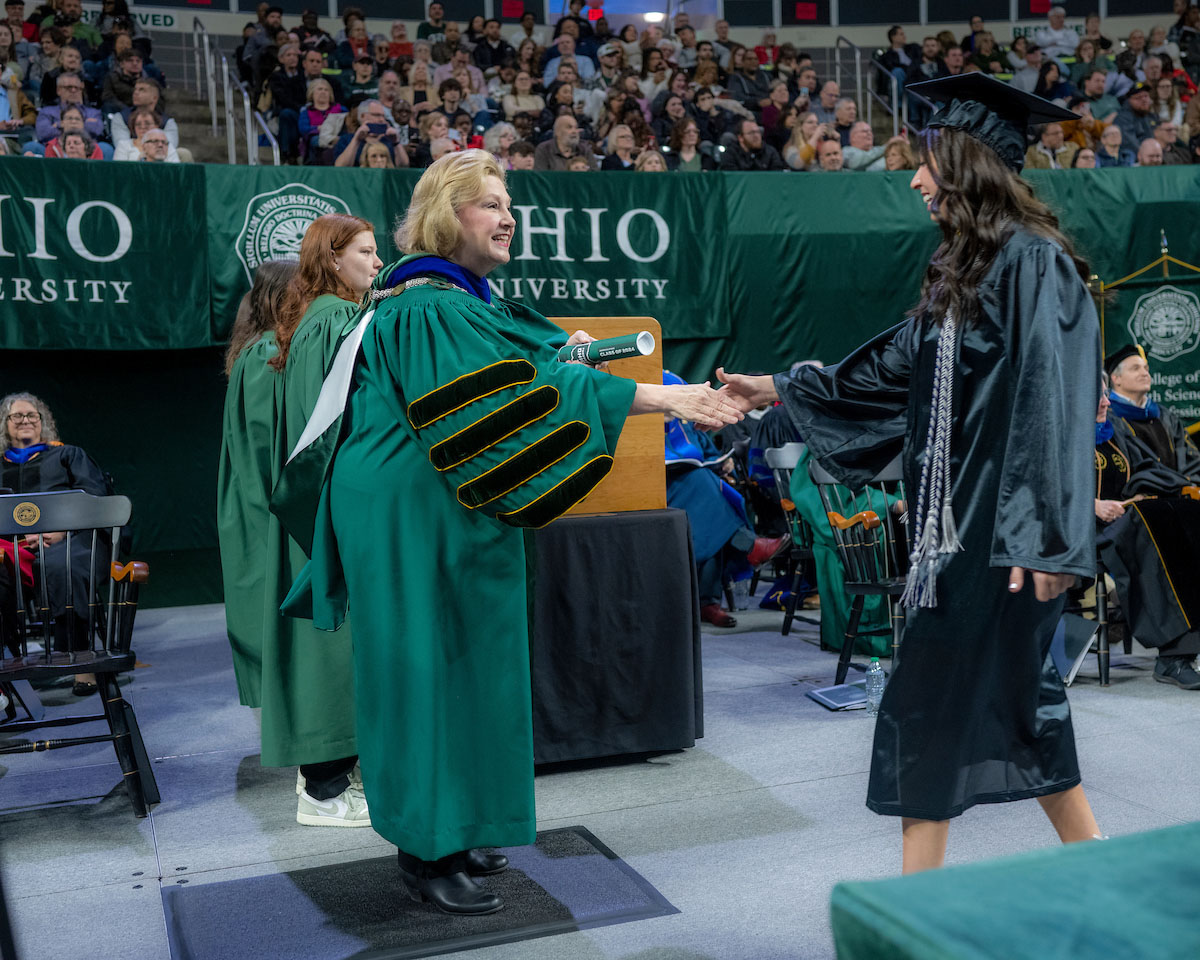 President Lori Stewart Gonzalez congratulates a graduating student at the Fall 2024 commencement ceremony