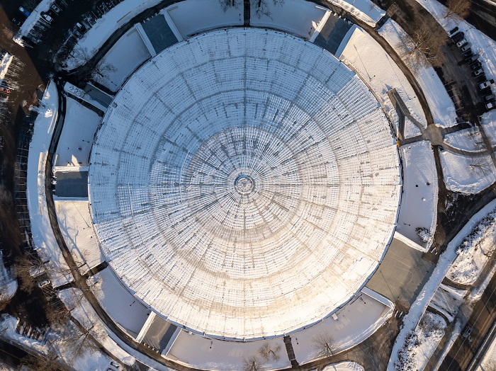 The Convocation Center is shown from above while the roof is covered in snow