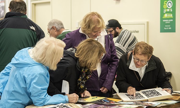 Ohio University alumni and friends took walks down their Bobcat memory lane, pouring over yearbooks, photographs, newspapers and student handbooks from across the decades at the Ohio University Archives Annual Homecoming Display.