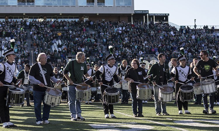 Members of Ohio University’s Marching 110 and the Marching 110 Alumni Band join forces for a halftime performance at the Homecoming football game.