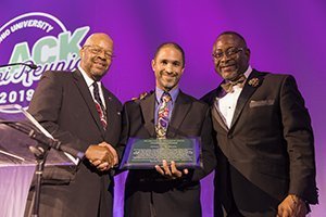 Alvin C. Adams III accepts the Ebony Bobcat Network’s Trailblazer Award on behalf of his late father, Alvin C. Adams, BSJ ’59, during the 2019 BAR Gala. He is pictured with Clarence Harris III, a representative of the Ebony Bobcat Network’s Chicago affiliate, and Ty Carr, MED ’00, the special assistant to the vice president for University Advancement and executive director of the Interlink Alliance. Photo by Max Catalano, BSVC ’20