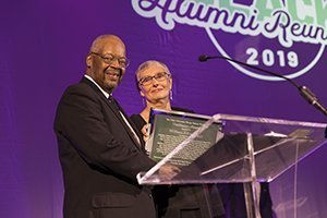 Carolyn Allen accepts the Ebony Bobcat Network’s Trailblazer Award on behalf of her late husband, Bill Allen, MED ’69, PHD ’77, from Clarence Harris III during the 2019 BAR Gala. Photo by Max Catalano, BSVC ’20