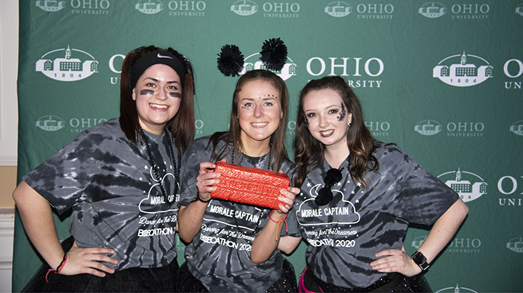 Members of BobcaThon’s Black Team (from left) Macie Michael, Abby Waldron and Samantha Pauley pose for a photo with the award they received for being the winning team of the night based on points they earned from playing games and earning “dancer of the hour” honors.