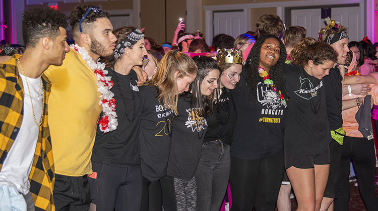 BobcaThon participants and fellow Ohio University students pose for a moment to reflect on the event and its purpose while listening to “Lean on Me.”