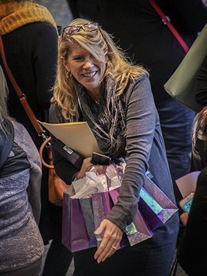 Candice Thomas-Maddox, co-chair of the Celebrate Women Conference and one of two 2019 Jane Johnsen Women of Vision Award recipients, navigates the morning crowd with gift bags at the 13th annual Celebrate Women Conference.