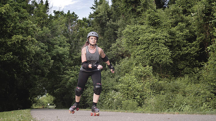 Amy Meeks, BSJ ’13, MA ’16, a member of the Appalachian Hell Betties Roller Derby Team who is featured in Ohio Today’s summer issue, practices her roller derby skills. 