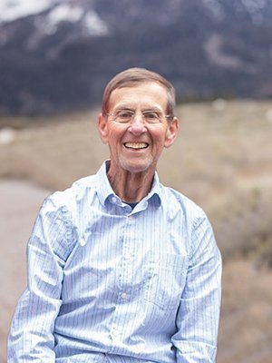 Dr. Wayne Pletcher is seen with mountains in the background. He and his wife’s latest gift to Ohio University, the Pletcher Science Scholarship, seizes on an opportunity provided through The OHIO Match, an undergraduate scholarship investment program through which the University has pledged up to $25 million to strengthen its endowed scholarship program.