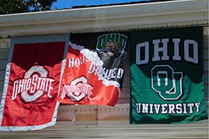 Banners for both Ohio University and Ohio State University hang outside the home of William and Sherry Rakatansky during the 30th annual OSU-OHIO Picnic at Lake Norman.