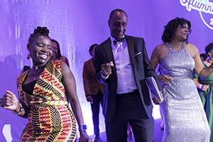 Dell Robinson joins fellow members of the 2019 Black Alumni Reunion planning committee in an impromptu “Electric Slide” dance during this year’s Black Alumni Reunion Gala. 