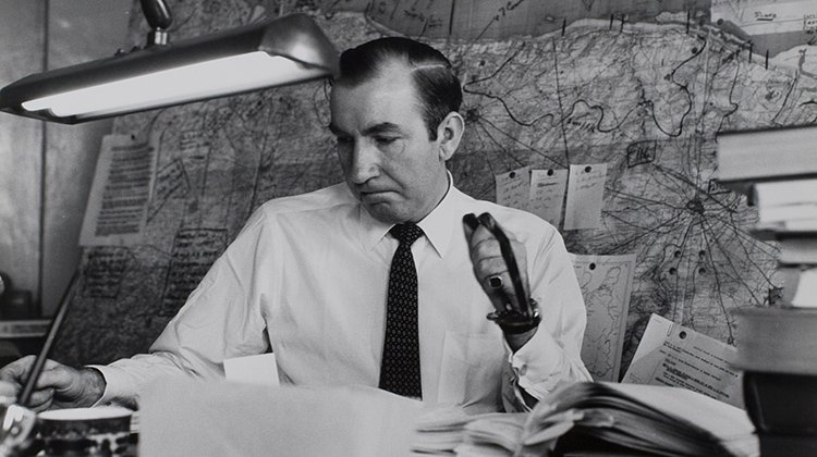 War correspondent, journalist, editor and author Cornelius Ryan is seen at his desk in this 1959 photo. 