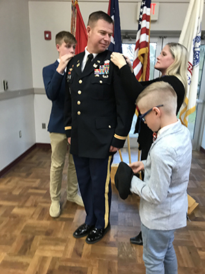 The family of Col. Andrew Stone, including (from left) son AJ Stone, wife Tanyah Stone and son Walker Stone, participate in a December 2019 pinning ceremony at the Athens Community Center. The ceremony, held in honor of Stone’s promotion to the colonel rank, was attended by many of Stone’s colleagues from the city of Athens, the Ohio Army National Guard and Ohio University President M. Duane Nellis.
