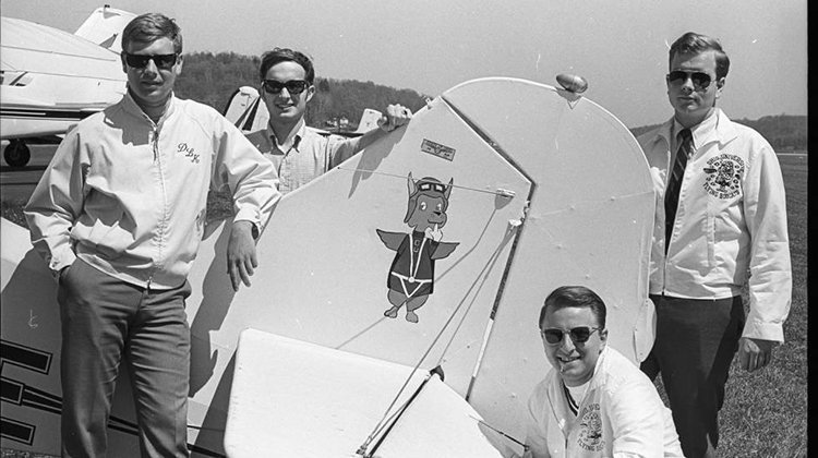 Members of the Flying Bobcats, including (back, right) Terry Timmester, BSJ ’69, pose for a photo with a new airplane in 1969.