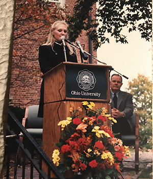 Heather Baird Tomlinson, BS ’00, speaks her sophomore year at Ohio University at an event honoring fellow OHIO graduate Wilfred Konneker, BS ’43, MS ’47, HON ’80, who, along with President Emeritus Charles J. Ping (pictured in the background) and Jack Ellis, established the Cutler Scholars Program.