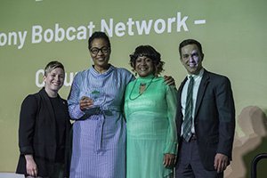 Tonya Mitchell, BBA’91, and Lori Peterson, BSJ’87, accept the Alden Community Service Award on behalf of the Ebony Bobcat Network’s Columbus affiliate. They are pictured with Erin Essak Kopp, assistant vice president for alumni relations and executive director of the OHIO Alumni Association, and Kyle Triplett, BA ’12, MBA ’17, chair of the Alumni Association Board of Directors’ Awards Committee. 