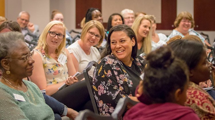 Women enjoy a laugh at the Women's Leadership Symposium