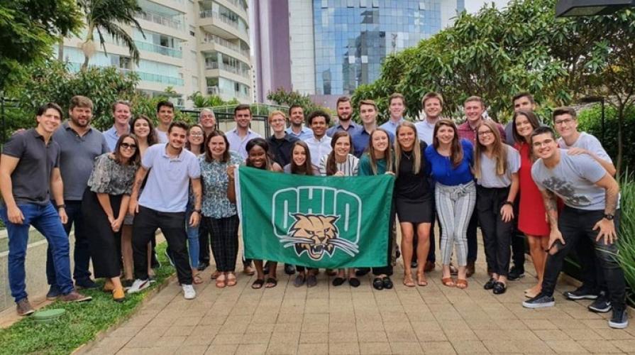 Students holding an OHIO flag while on a trip to Brazil