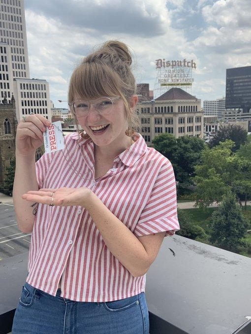 Abbey Marshall holds up her press pass for the Columbus Dispatch.