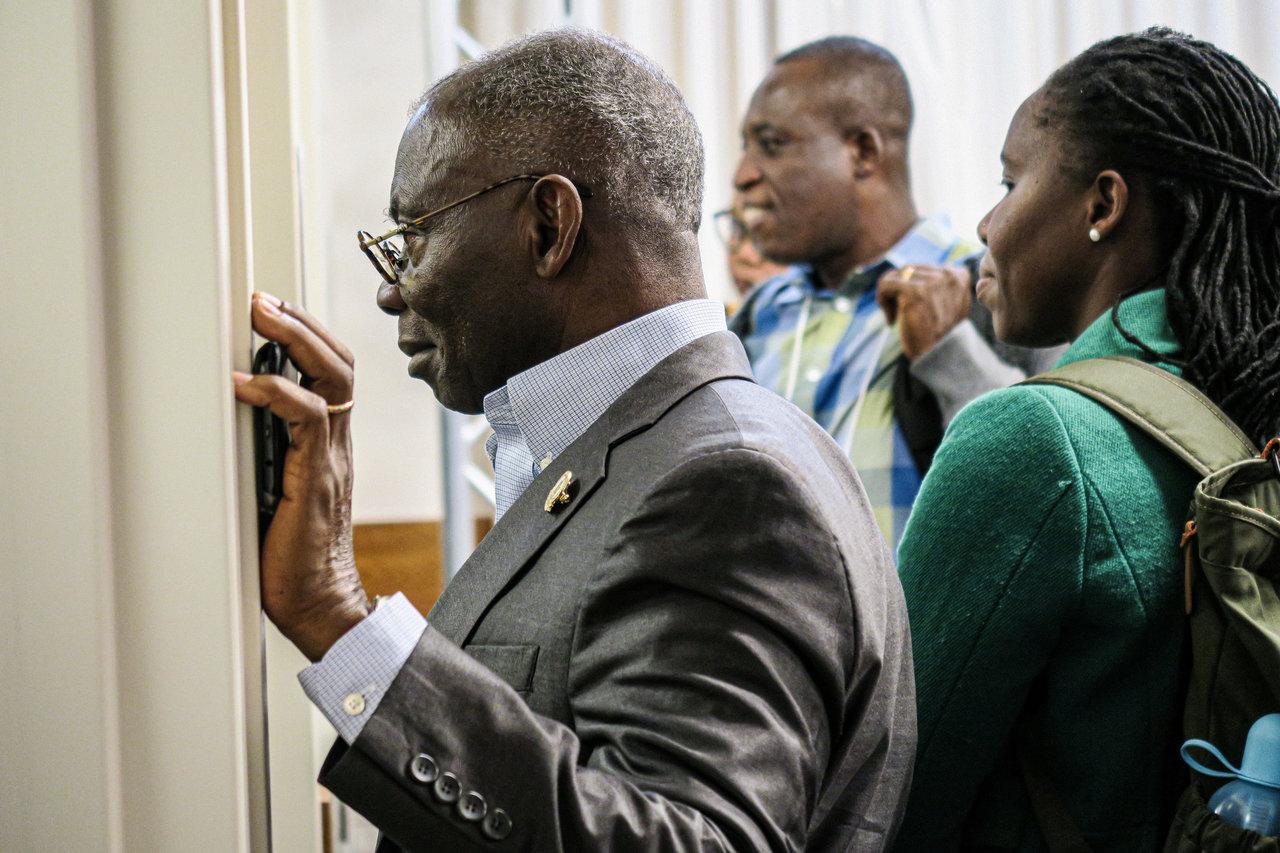 Dr. Yeboah Marfo-Debrekyel from Garden City University College in Ghana looks at a GRID Lab presentation during the Global COIL Symposium. Photo by Alaina Bartel