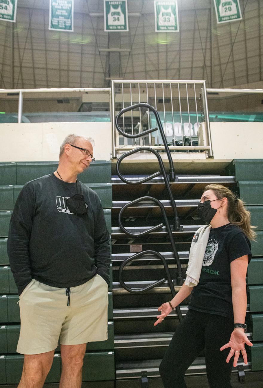 Head coach Jeff Boals talks to student manager Jess North in the Convo Center