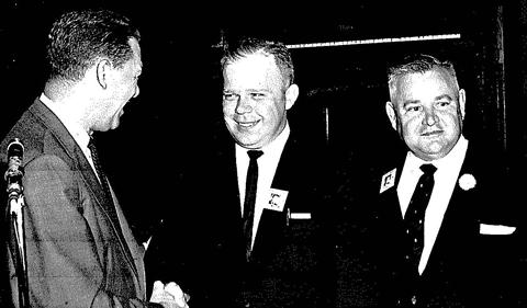 James Parobek shaking hands with men at banquet