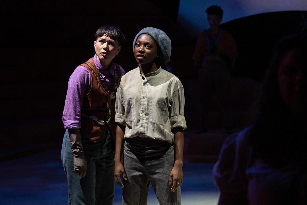 Two actors on a dark stage