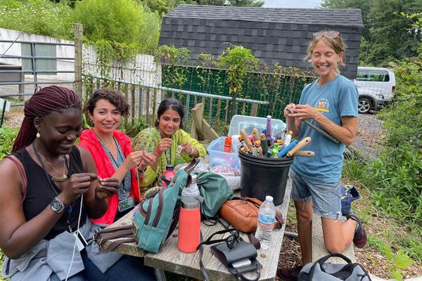 Fulbright scholars work with the Community Food Initiatives at the community garden.